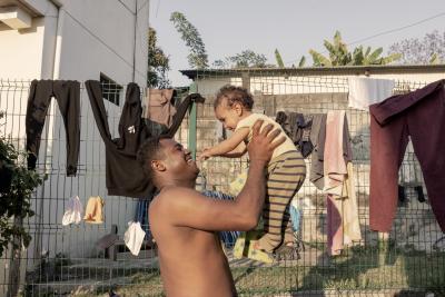 A man playing with his child.